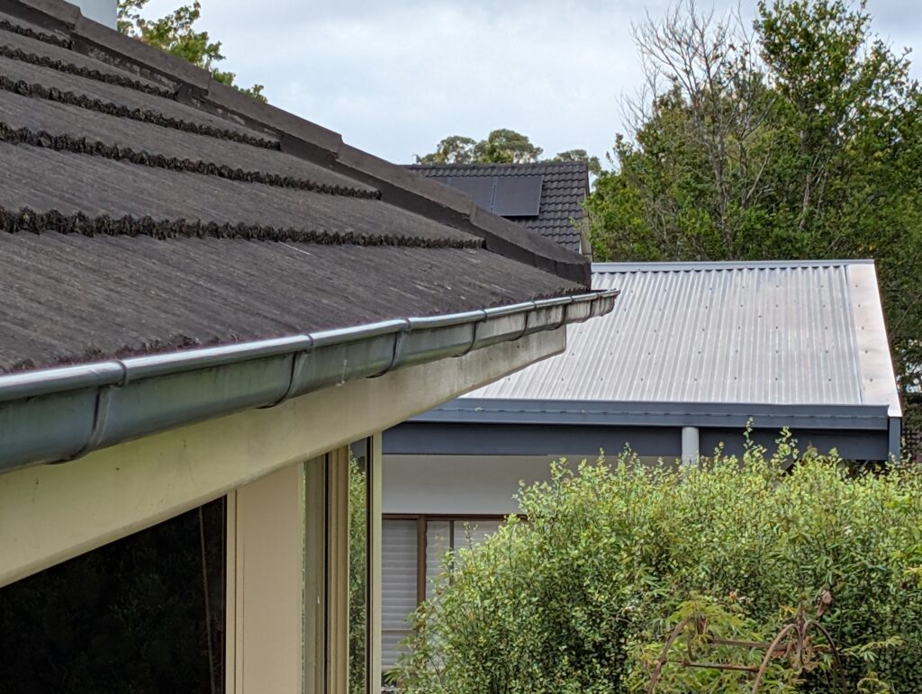 A clean and cleared roof gutter system on a residential home after professional maintenance services.